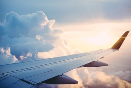 image of an airplane wing flying through the sky