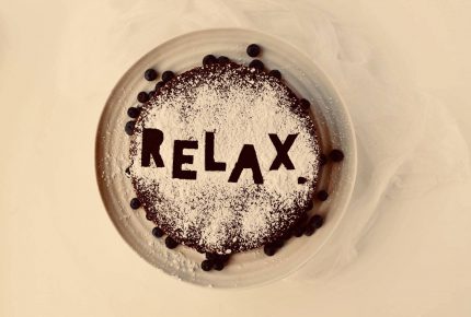 Relax written in coco powder on top of a hot drink