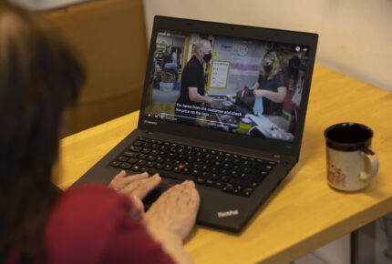Trainee at All Together Edinburgh is seen using laptop to access online training programme