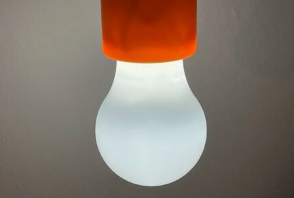 White light bulb in orange fitting.