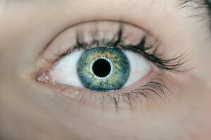 image shows a close up of an eye with tracking lights projected onto it